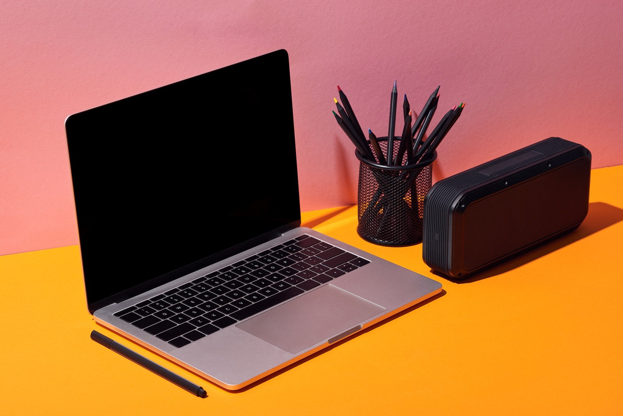 Picture of laptop, pen container, and alarm clock on desk. BC Stack Review