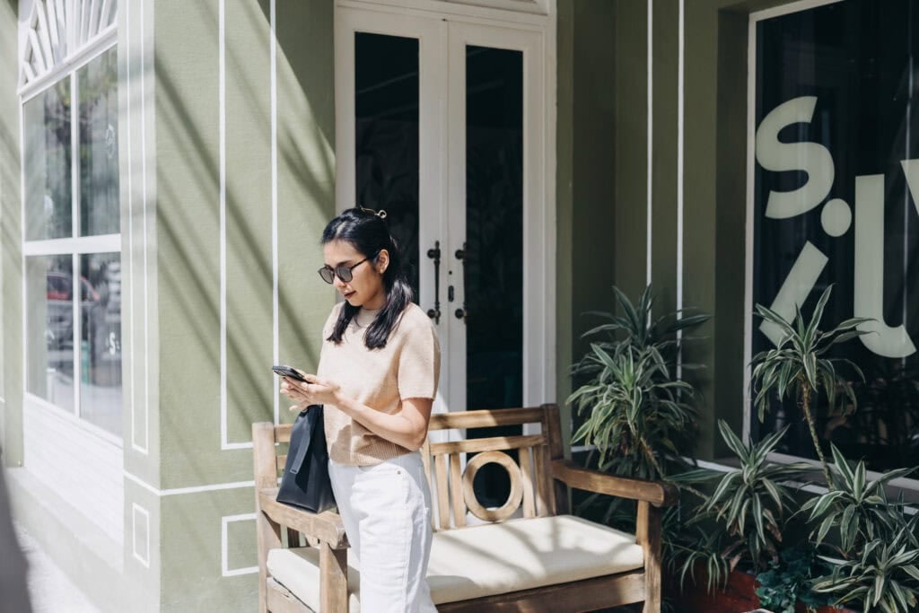 woman on phone outside of store